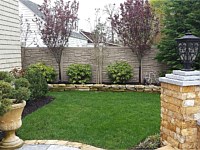 <b>Brown Granite Ecostone Simtek Fence in backyard</b>